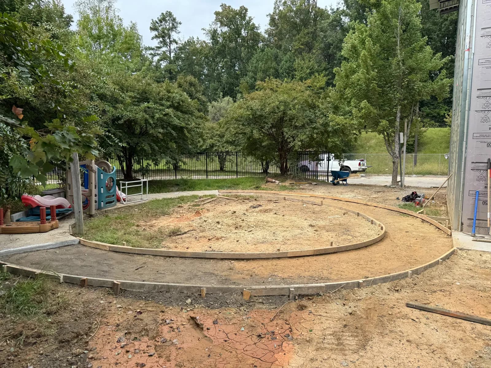 Curved wooden forms set in dirt for a circular walkway