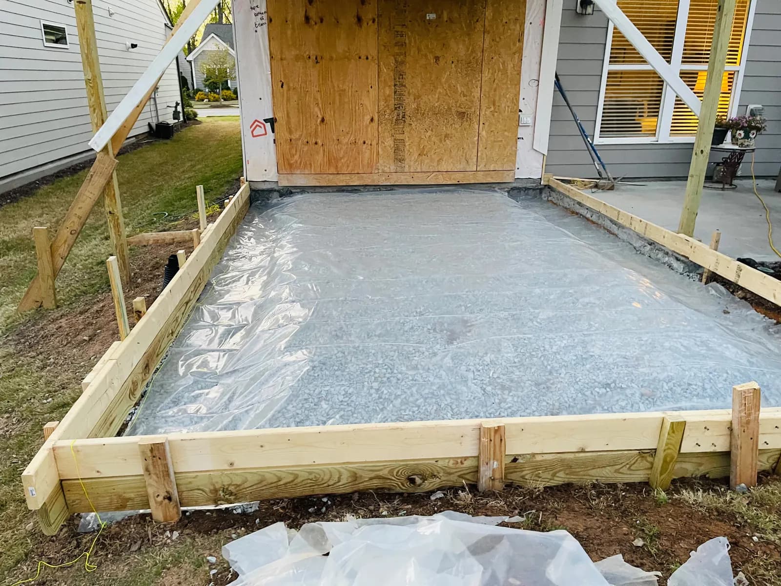 Patio area formed with gravel and vapor barrier before the pour