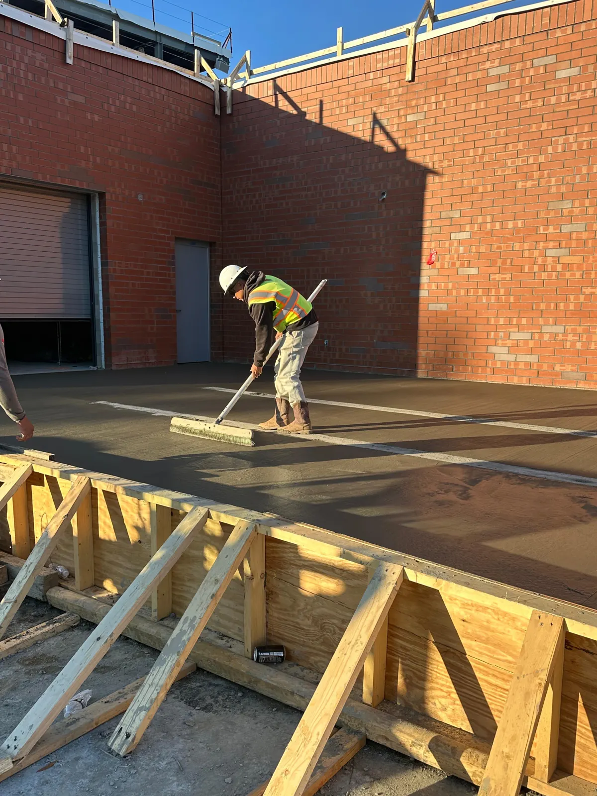 A&V crew member finishing a freshly poured concrete slab